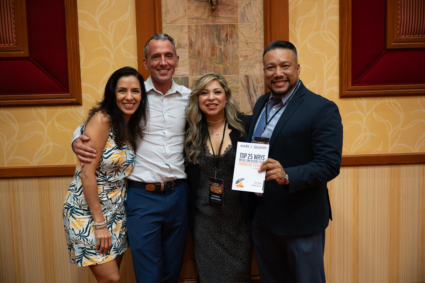 Mark Quann with attendees holding his book at Elevate 2026 in Las Vegas