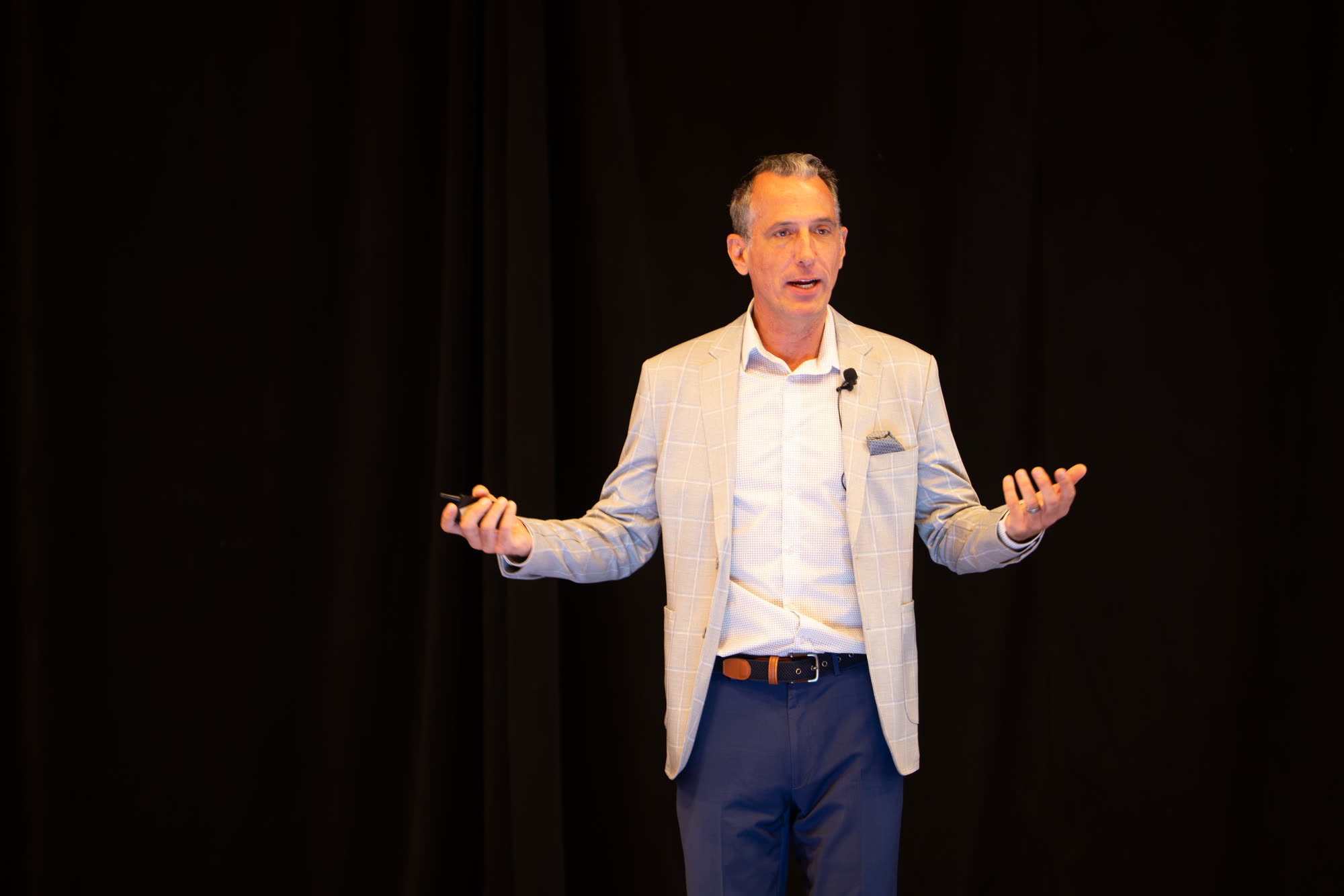 Mark Quann speaking on stage at Elevate 2026 in Las Vegas